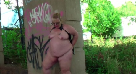 BBWW Lexie Cummings, who is still in her mid-twenties, exhibits her pierced cunta below an overhead bridge.