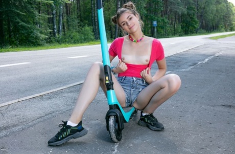 Cute teen Lisa gets naked in sneakers after riding her scooter to a park