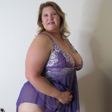 Before getting naked against a wall, Busty Krisann stands while disrobing lingerie as an unprofessional person.