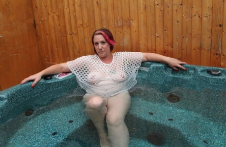 In an outdoor hot tub, Sara Banks, a young and plump woman, goes completely naked.
