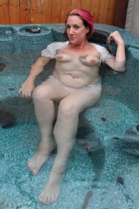 Sara Banks, a young woman with ample height, takes a naked plunge into an outdoor hot tub.
