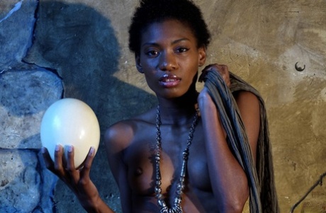 Dark Skinned Girl Jess Holds A Large Egg While Modeling Butt Naked