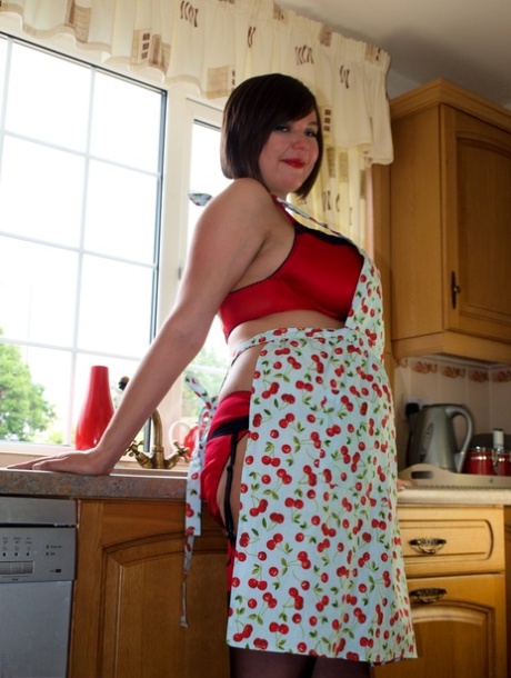 Roxy, a fat lad, exposes her substantial breasts covered in lingerie and a kitchen towel.