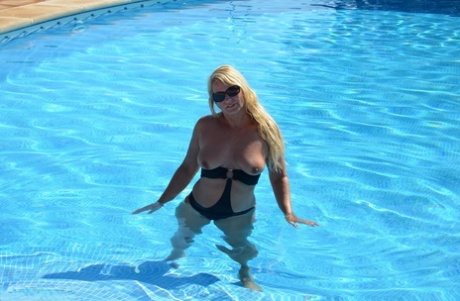 Middle-aged Blonde Sweet Susi Frees Her Tits & Pussy From A Swimsuit By A Pool