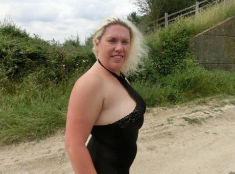 Extensive: Blonde amateur Barby expose her fat body in a rural setting.