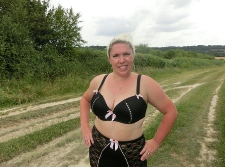 In a rural setting, Barby, a blonde amateur, displays her obese physique.