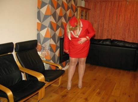 In her work uniform, blonde BBW Chrissy Uk loses all of these bodily features as she loosens her tits and pussy.