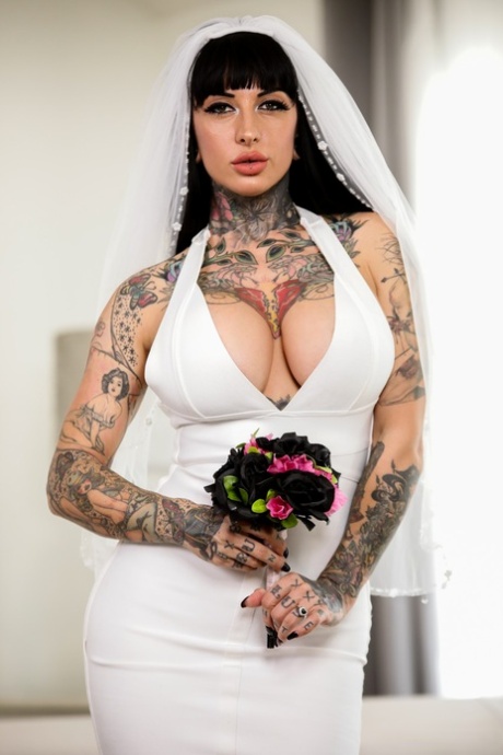 Prior to engaging in anal sex, Jessie Lee's black bride with tattooed hands writhes deeply and sedates her partner.