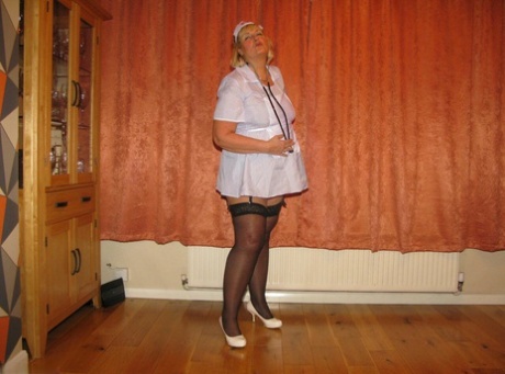 Fat nurse Chrissy Uk removes a surgical mask and uniform to model lingerie