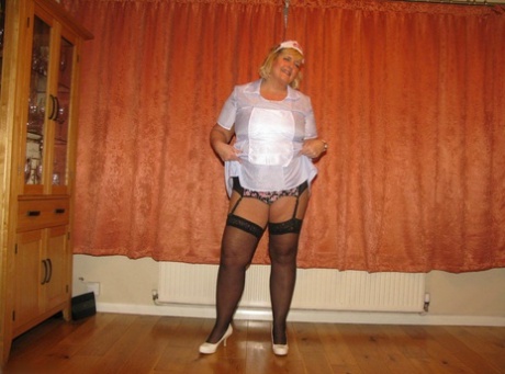 With a surgical mask and uniform on her back, fat nurse Chrissy Uk models her own lingerie.