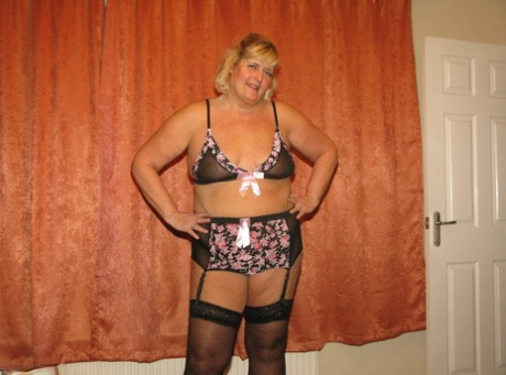 Chrissy Uk, a nursing woman who is overweight, removes her surgical mask and uniform to showcase her lingerie.
