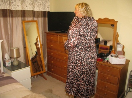 In her bedroom, blonde fatty Chrissy Uk places her labia lips on top of a chair.