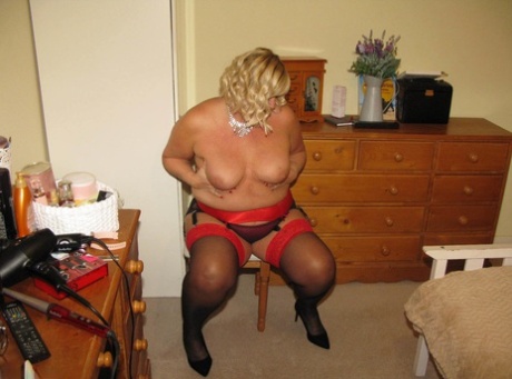 The labia lips on a chair are shared by Chrissy Uk, an older blonde and fat woman in her bedroom.