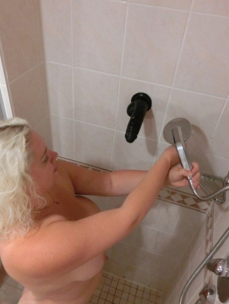 Hot, hardcore action: Over-the-top blonde amateur Barby takes a shower on her bed as she brushes off the hot air.