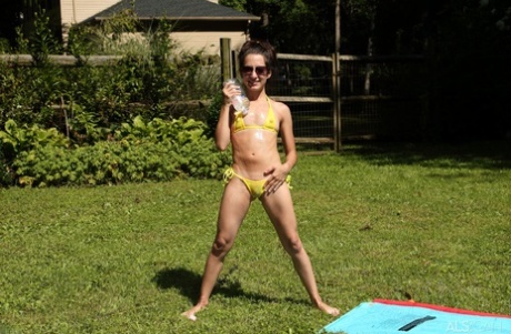 Skinny teen Freya Von Doom takes a piss before fisting her pussy in a backyard