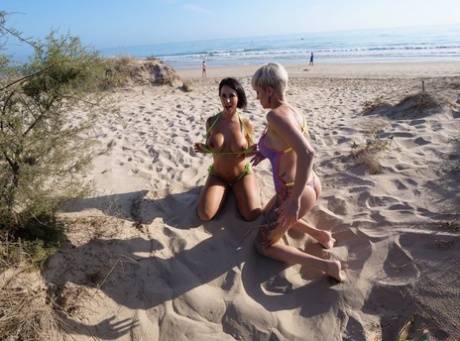 Ibi Smiles And Tanya Virago Free Their Boobs From Swimwear On A Beach