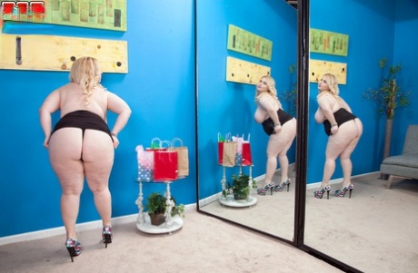 In the mirror, BBW woman Nikky Wilder displays her substantial chest and buttocks.