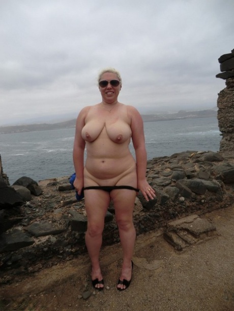 Wearing nothing but clothes: At one beach, Barby the adult amateur gets completely naked in shades.