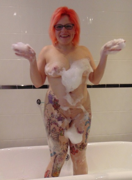 Bubble bath: Tattooed amateur Mollie Foxxx puts on her glasses while taking a deep breath.