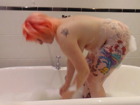 Bubble bath with glasses: Tattooed amateur Mollie Foxxx gets ready.