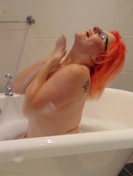 The tattoo-wearing amateur, Mollie Foxxx (left) takes a bubble bath while her glasses are on.