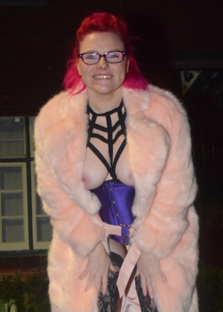 Mollie Foxxx, a redheaded amateur, flashes in a long coat during the night.