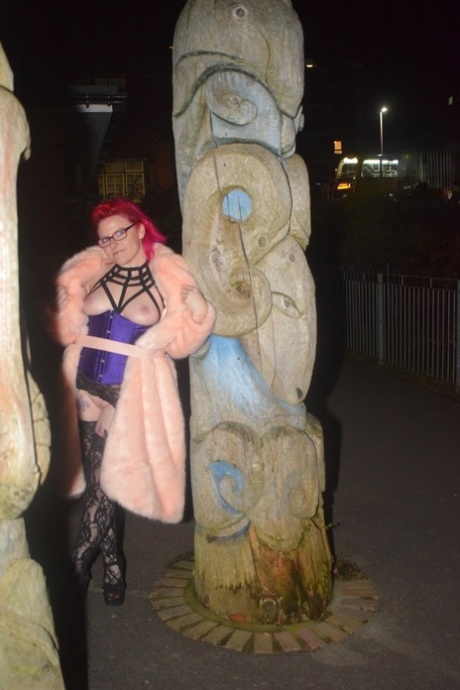 A long coat by redheaded amateur Mollie Foxxx makes her flash during the night.