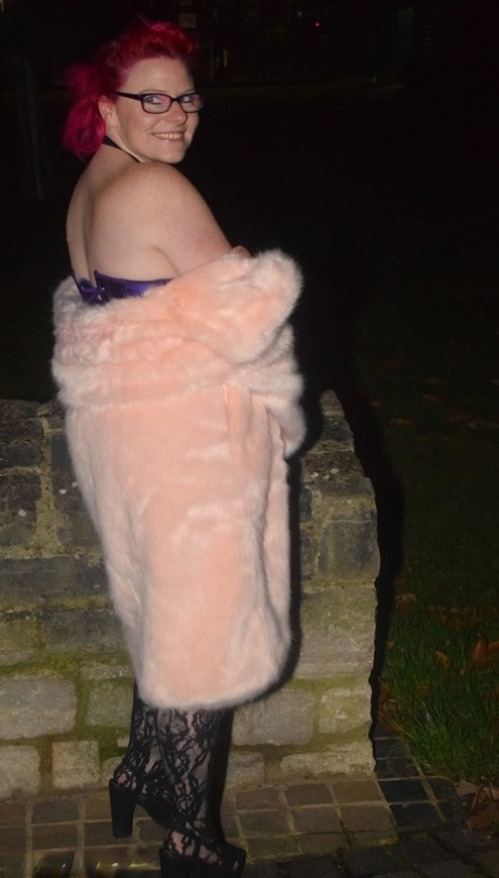 While wearing a long coat, Mollie Foxxx, the red-headed amateur breed, flashes at night.