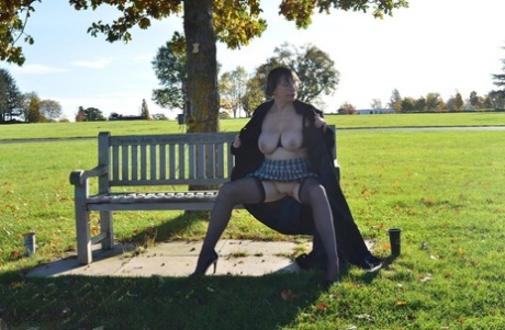 Public places: Middle-aged amateur Barby Slut wears a long coat and exposes herself in the sun.