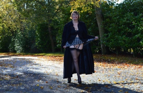Barby Slut, a middle-aged amateur, exposes herself in a long coat while out in public.