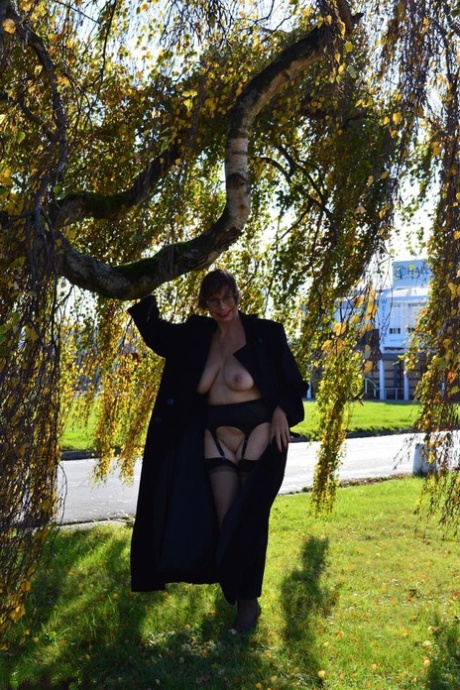 Wearing a long coat, Barby Slut exposes herself in public places as an amateur of middle age.