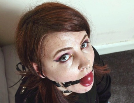 Despite being tattooed red, Luna La Roux is seen wearing straps and performing a ball gag.