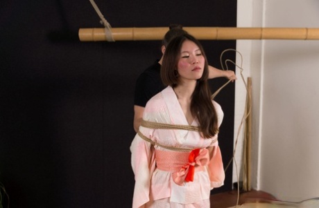 Having long hair and an untied body, the Asian female Flawless Meow is tied up with rope.