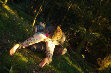 Anuskatzz & Lily Lu engage in sexual activity on the forest floor with their tamed accomplices.