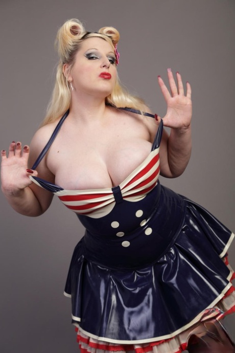 Avengelique, a curvy blonde, releases her large tits and buttocks from a latex dress.