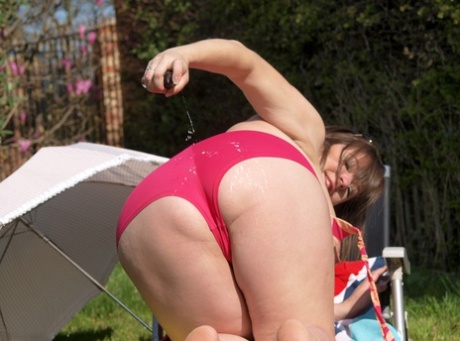 In a sun-kissed manner, amateur BBW Roxy is seen out on the lawn chair in a naked state.