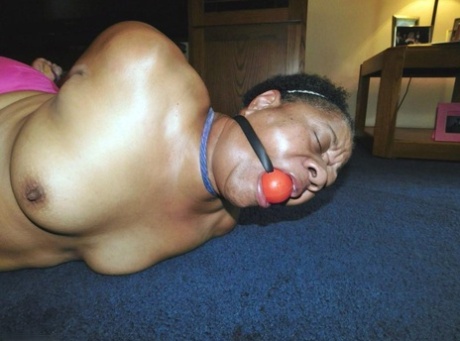 Overweight Black Woman Trixie Struggles Against A Ball Gag While Hogtied