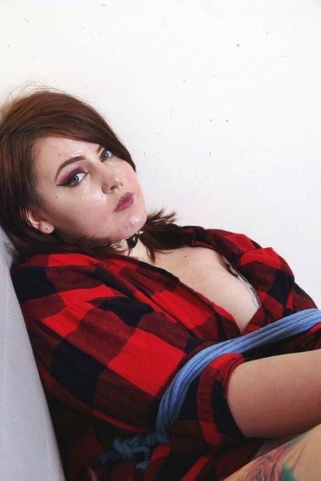 In the picture, Luna La Roux is seen holding onto a futon and being gagged with her legs in an awkward position.