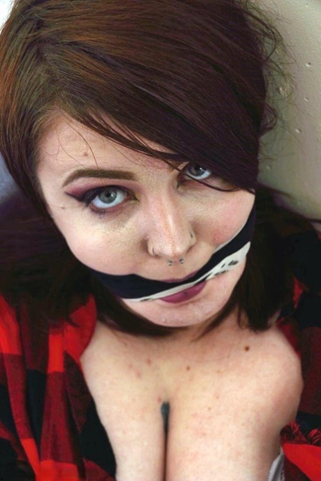 Rugged squirt named Luna La Roux gets tightly bound on top of the futon while being gagged.