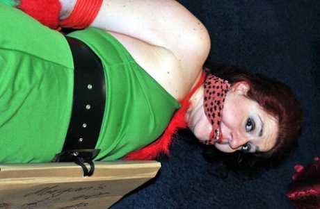 Busty Redhead Is Restrained And Gagged In Christmas Outfits