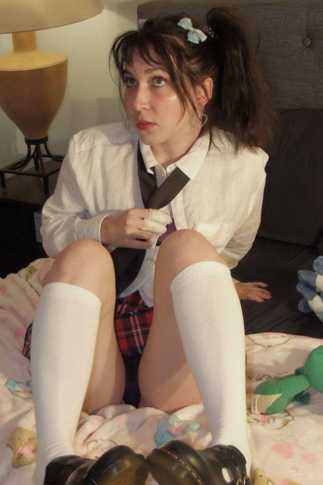 Ball gagged and tied up in uniform, a young student exposes her thong.