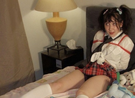 Ball gagged and tied up in uniform, a young student exposes her thong.