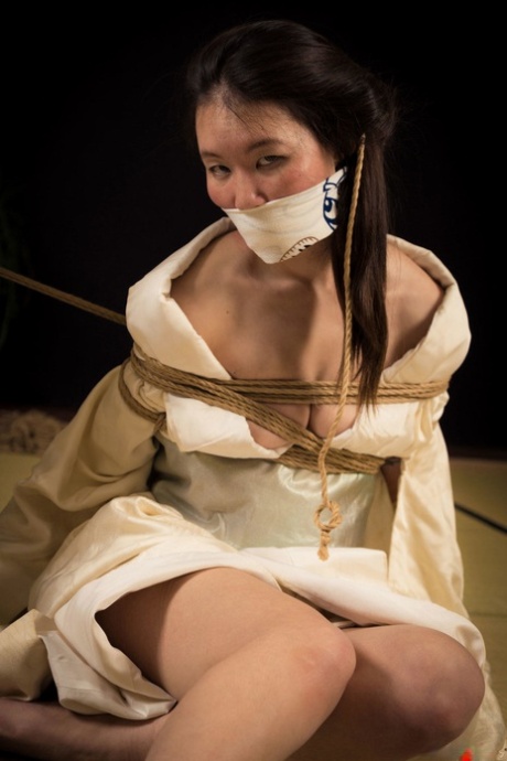 The Japanese female Flawless Meow is tainted by a gaunt during a Shibari session.