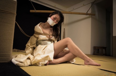 The Japanese female Flawless Meow is subjected to gaffes during a Shibari session.