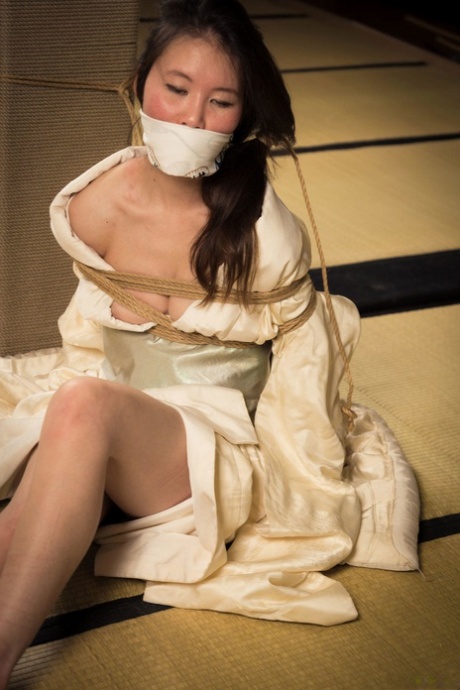 In a Shibari session, the Japanese female Flawless Meow is taunted and subjected to gabbing.