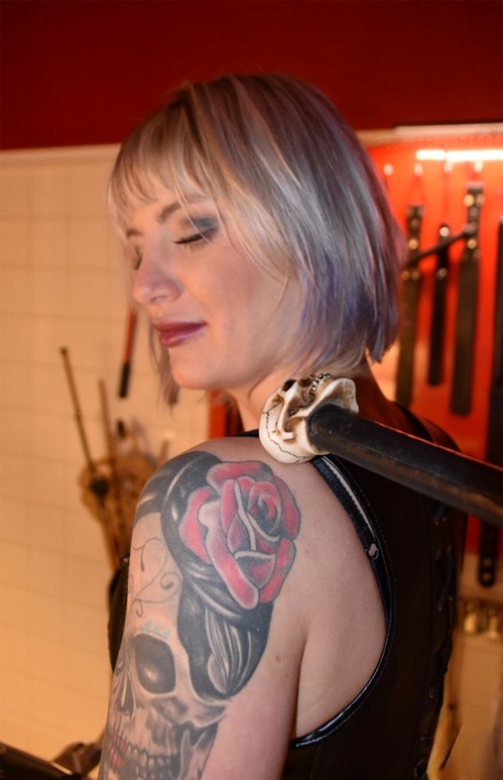 Roxxxi Manson wears a mouth spreader while wearing a collar and cloth.