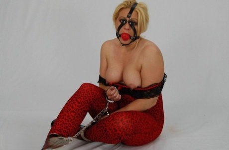 The thick blonde is entangled in chains and subjected to a ball gag until their penis is fully developed before the cock is sucked.