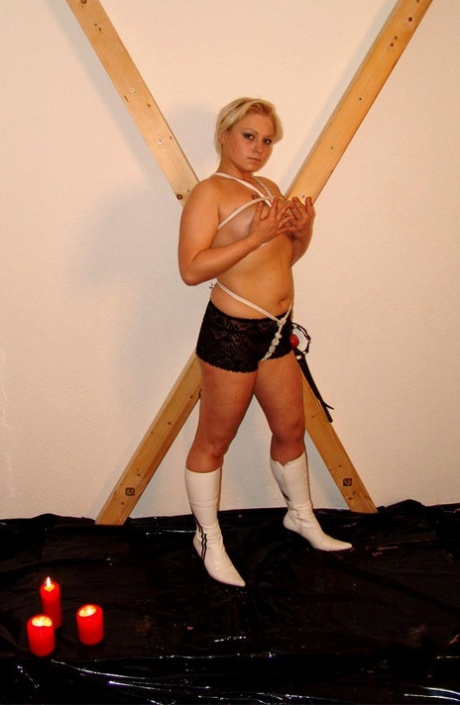 Blonde chick Katharina is tied to a St Andrew's Cross during non-nude action