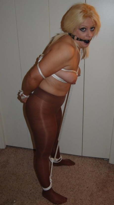Chubby Blonde Adrienna Sports A Ball Gag While Tied Up In Shiny Pantyhose