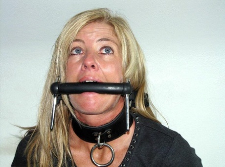 Blonde Woman Is Gagged While Her Ankles And Wrists Are Bound With Rope